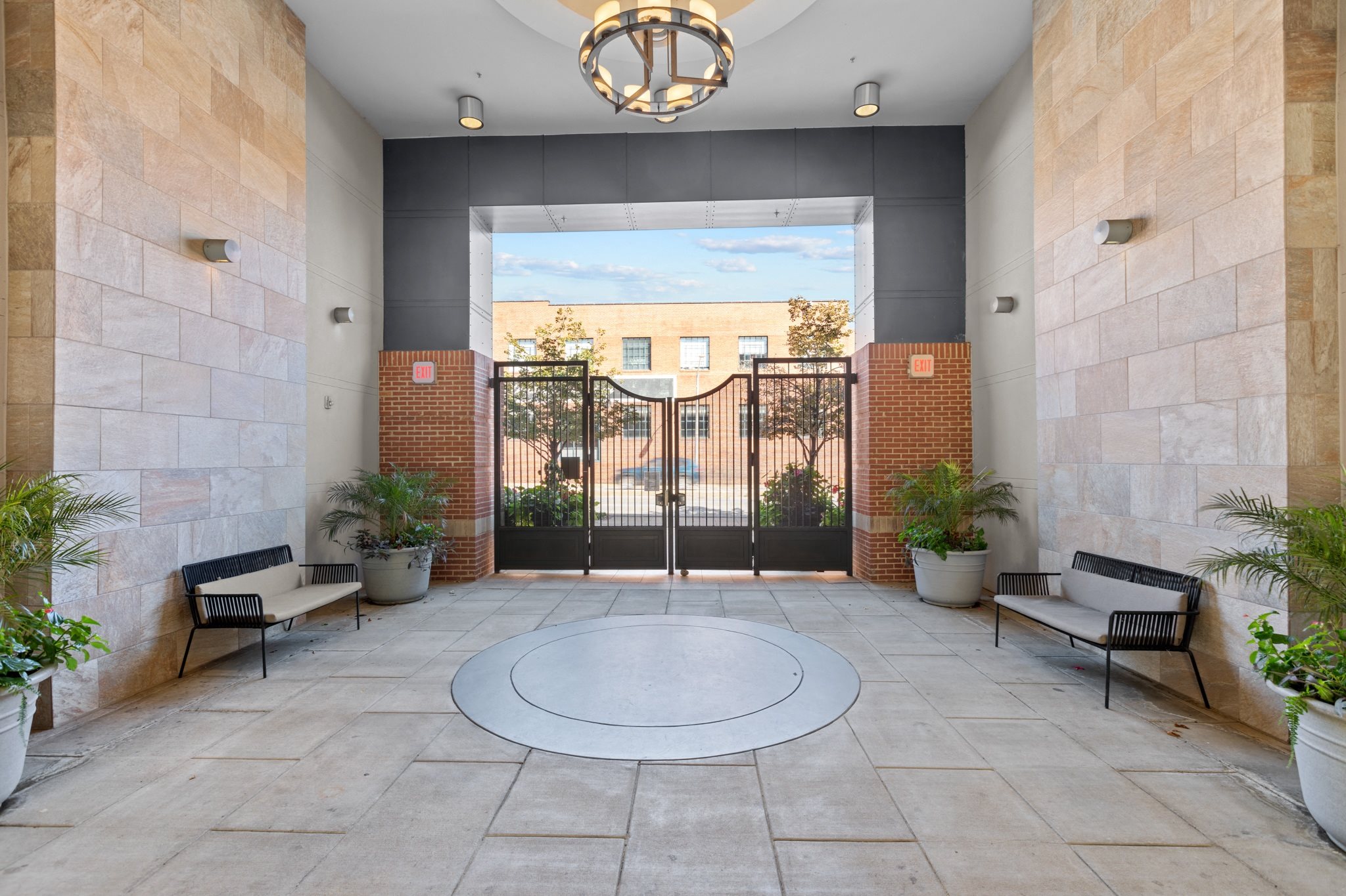 the entrance to a building with a door and a circular rug in the center of